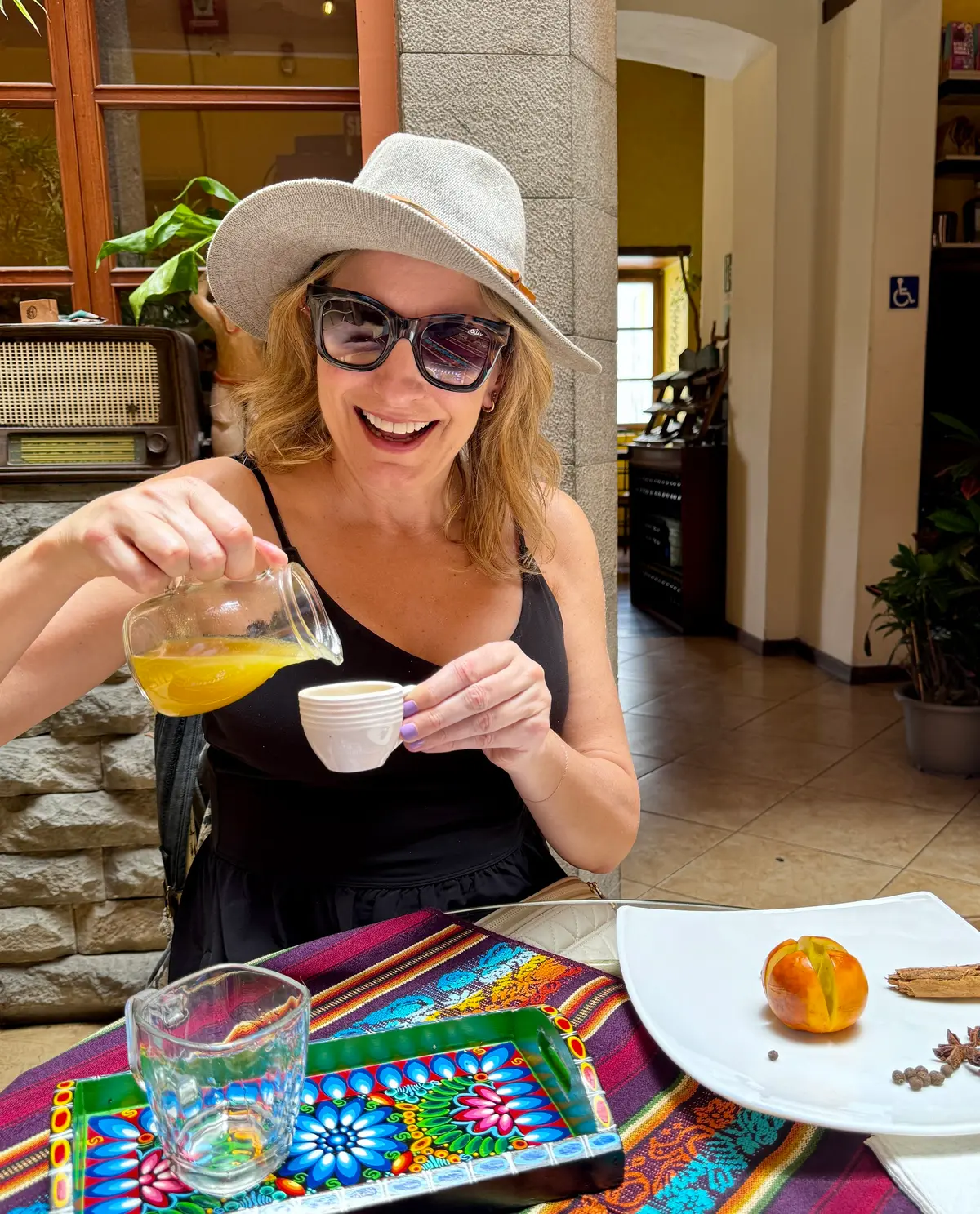 Julie Hartigan pouring tea at a hotel breakfast