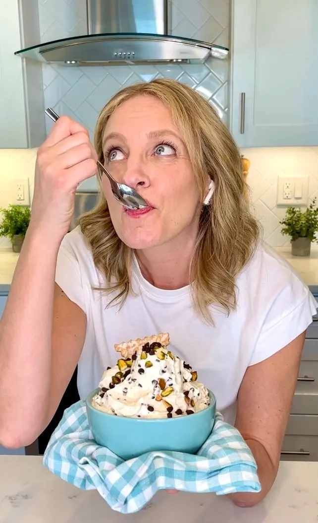 Julie Hartigan tasting an imported cheese dessert