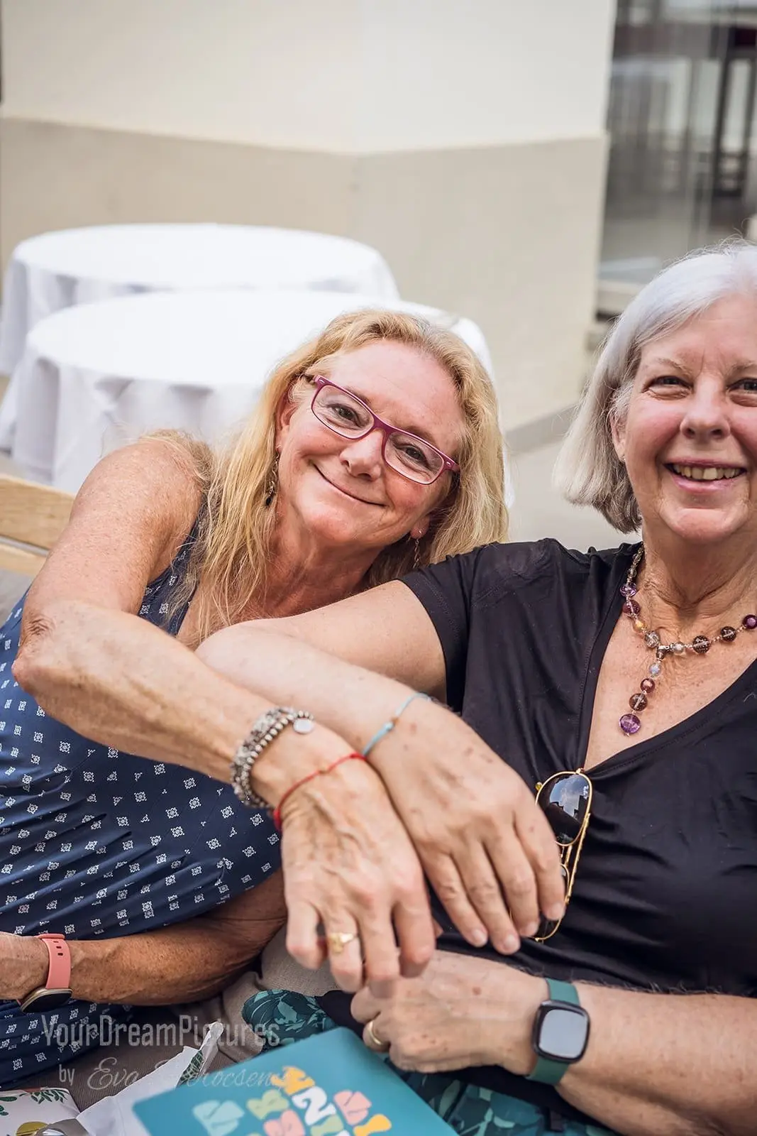Two friends showing their bracelets