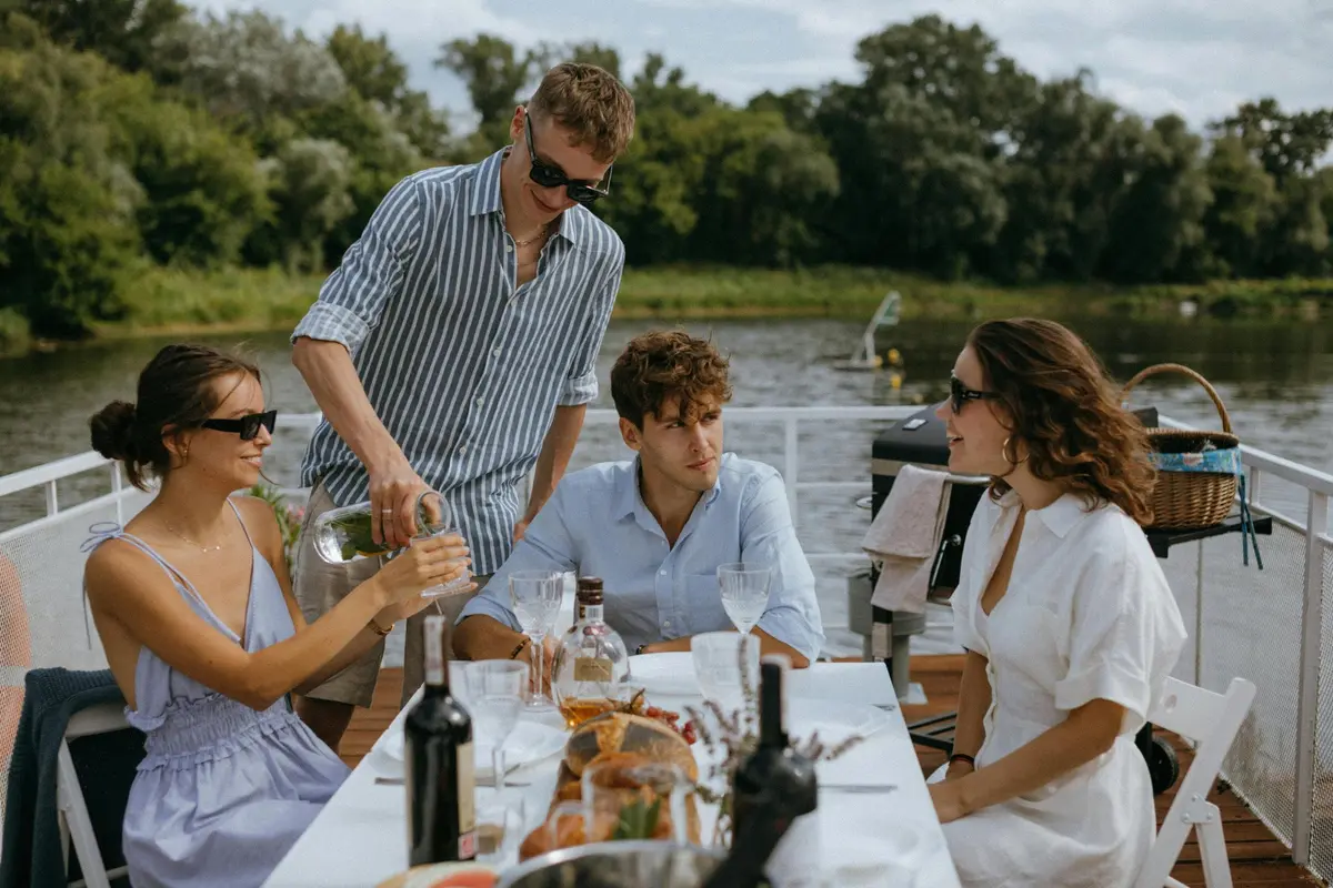 Friends sharing wine and lunch on a boat