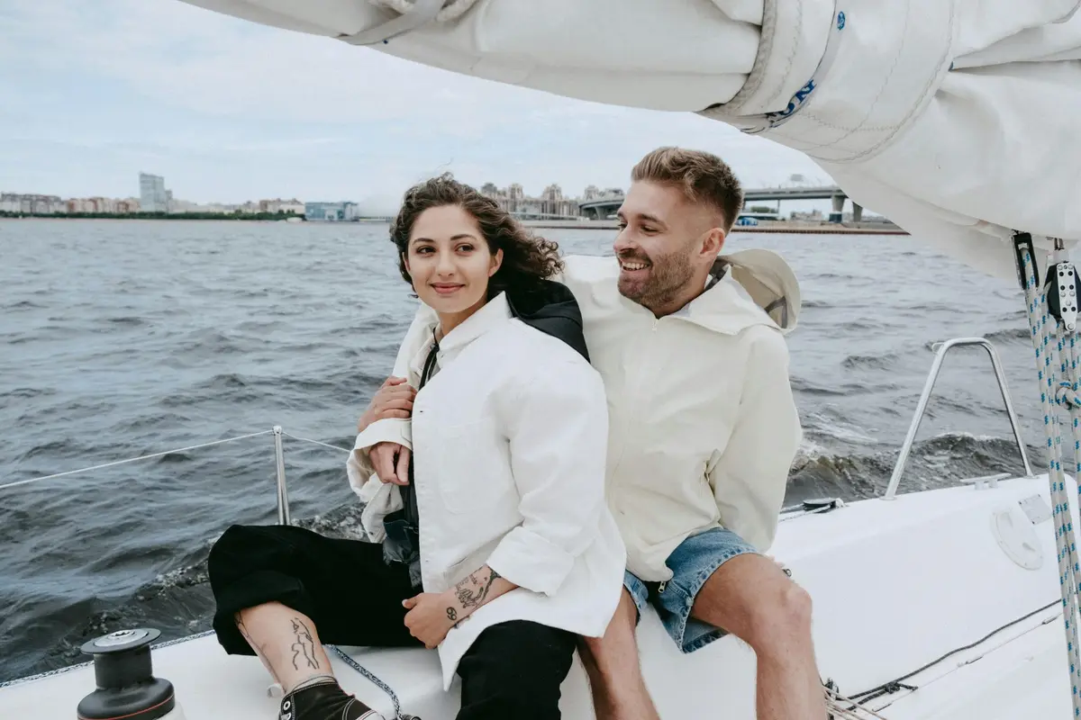 A couple relaxing on a sailboat