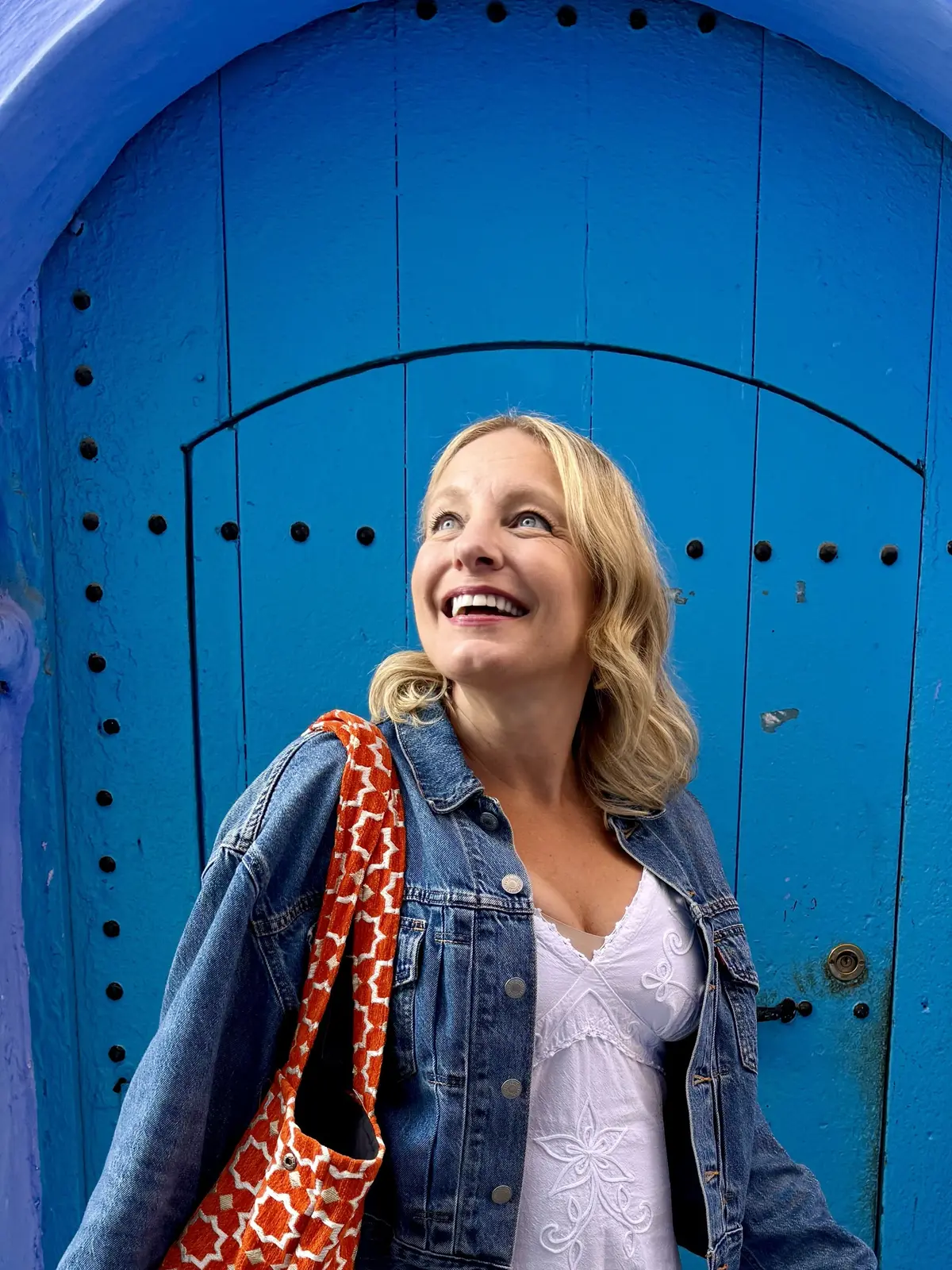 Julie Hartigan in front of a blue door in Morocco